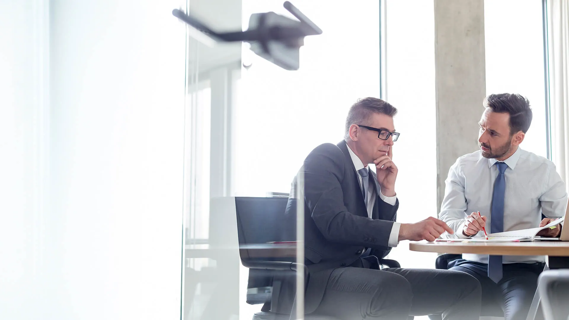 Two colleagues reviewing a document together in a bright office